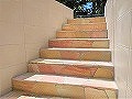 2022年5月施工の東京都世田谷区Ｔ様邸外構リフォーム画像/道路から玄関までの下り階段を天然石貼りに施工した例