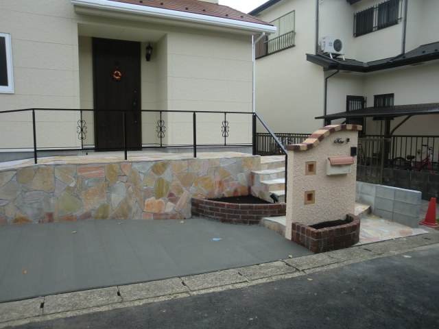 世田谷区の外構工事│車庫コンクリート打ちとカーブ形状の門柱、玄関スロープに手すりを設置したオープン外構